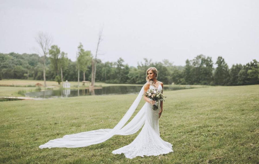 Bride standing in an open field at a farm wedding venue near Nashville
