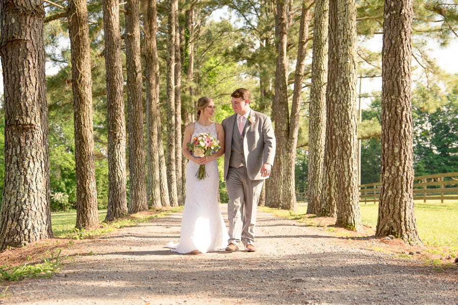 Bride and groom walking through Rural Hill Farm