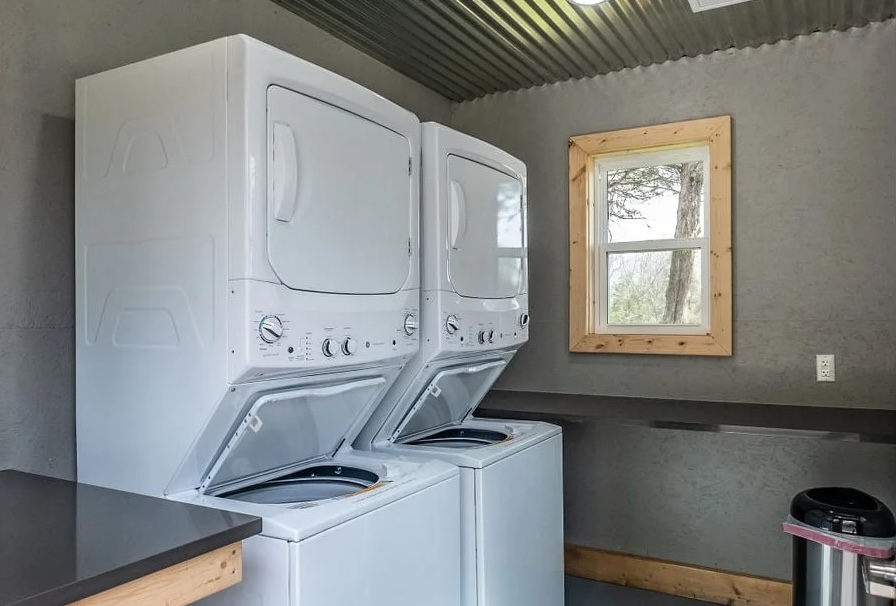 Clean and modern laundry facility with stacked washers and dryers at an RV campground.