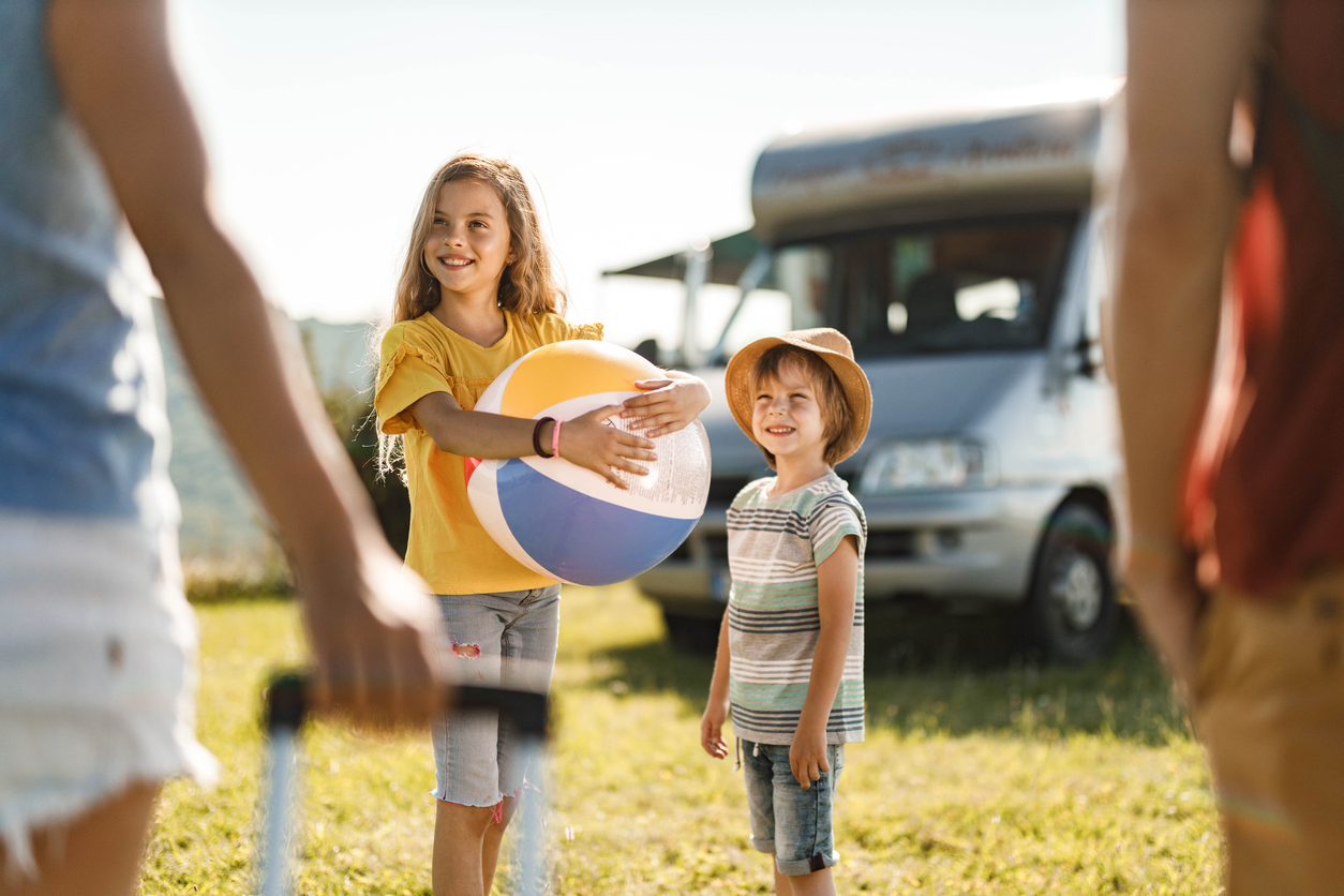 Family arriving at an RV campsite for a weekend camping trip