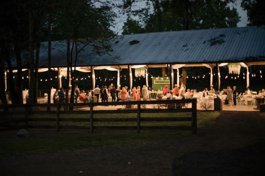 Rural Hill Farm's event center at night with lights and a party.