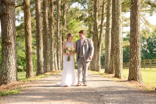 Bride and groom walking through Rural Hill Farm