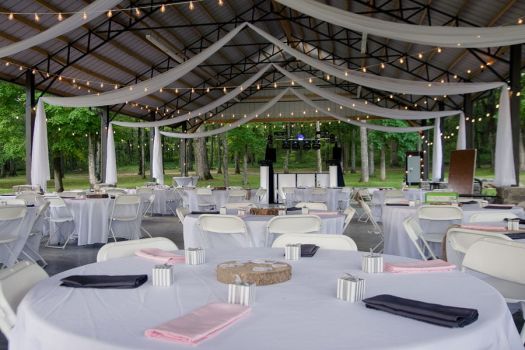 Wedding reception tables set under a decorated pavilion at Rural Hill Farm outdoor wedding venue near Nashville TN