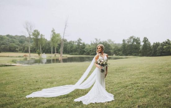 Bride standing in an open field at a farm wedding venue near Nashville