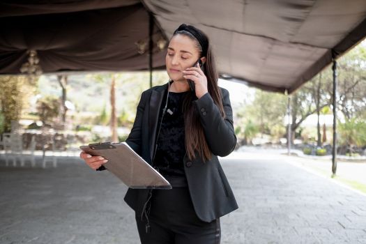 Wedding planner reviewing event details at an outdoor wedding venue