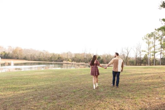 Couple walking beside the pond at Rural Hill Farm during a photoshoot